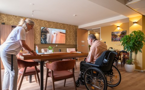 meneer in rolstoel aan het sjoelen