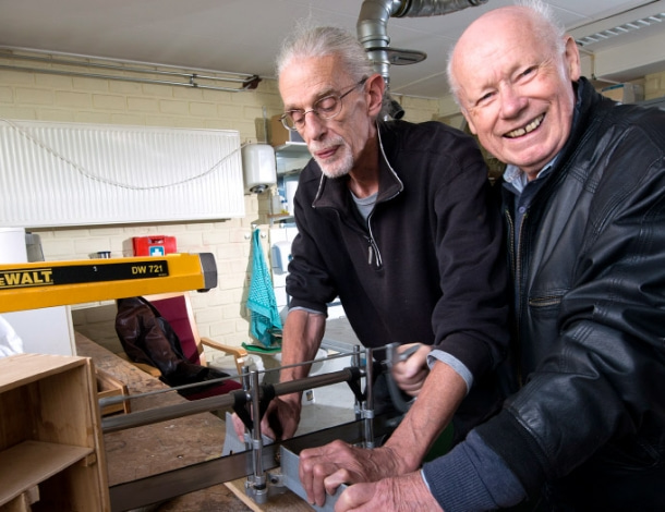 Twee oudere mannen in doe-het-zelf timmer werkplaats